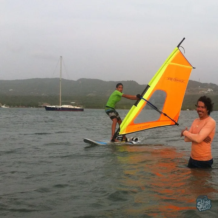 Instructor de Uma acompañando a un joven en la tabla